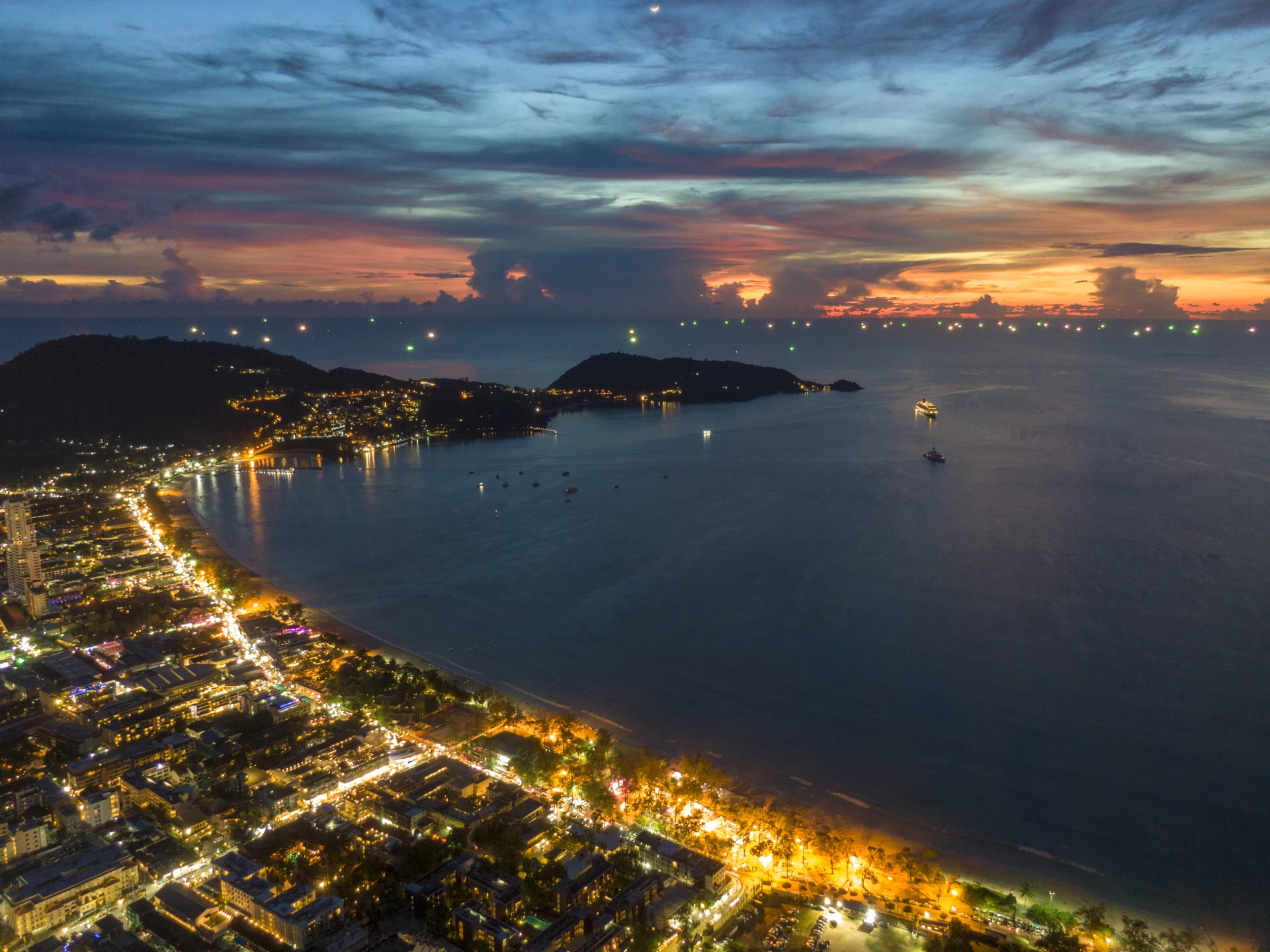 Bird's-eye view of Patong Bay on Phuket Island at sunset at night