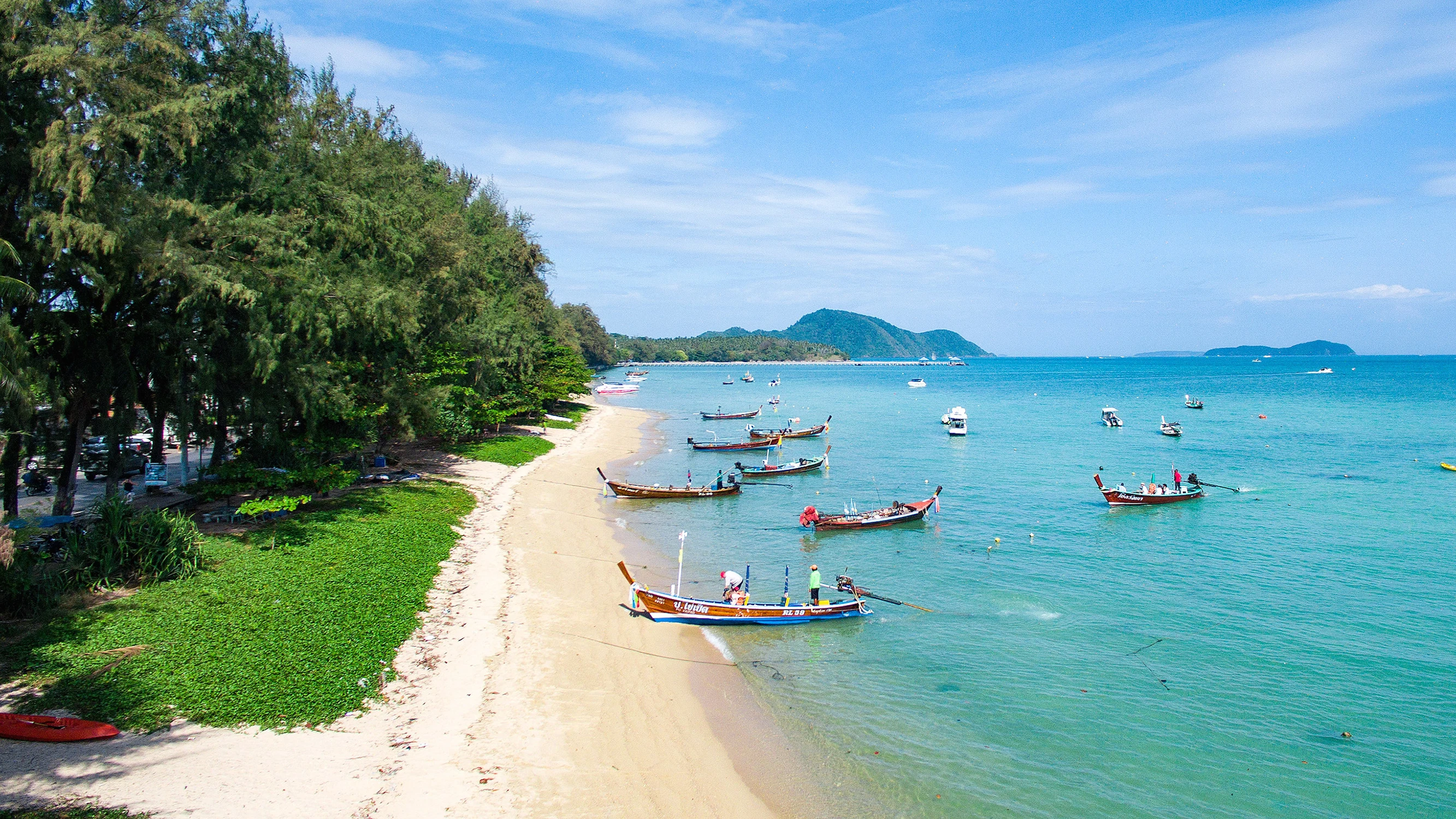 Rawai beach with boats parked near the shore